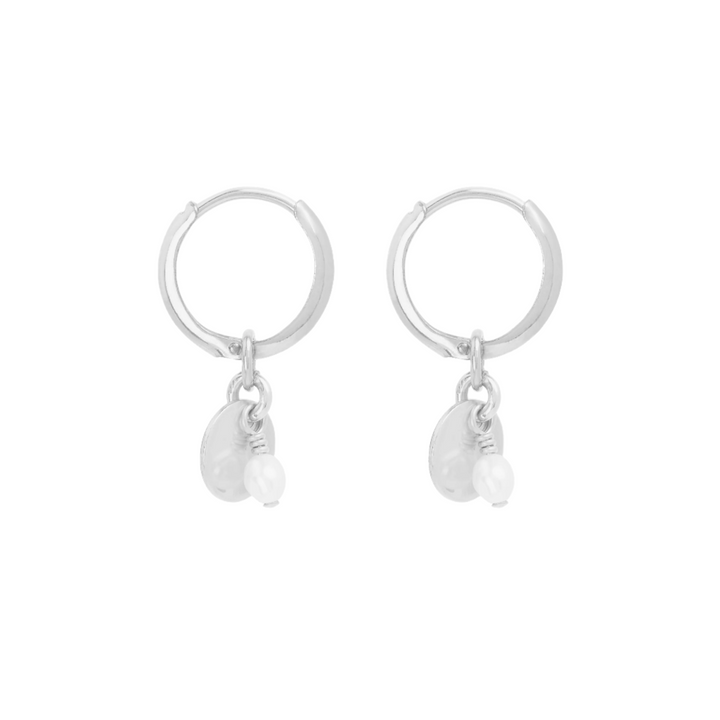 A pair of small silver hoop earrings with a flat disc featuring a small freshwater pearl, presented against a white background.