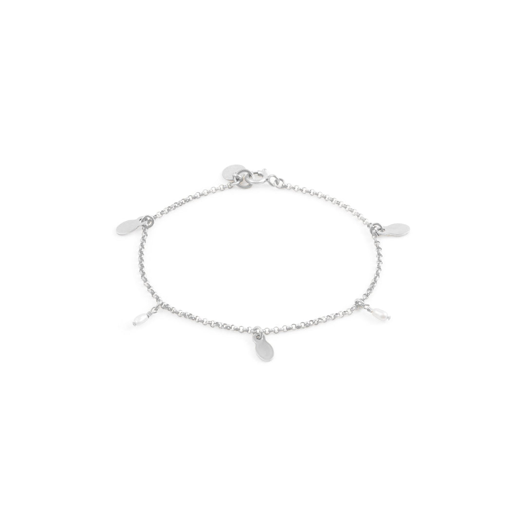 A Sterling Silver bracelet featuring a rolo chain with attached freshwater pearls and flat oval discs.
