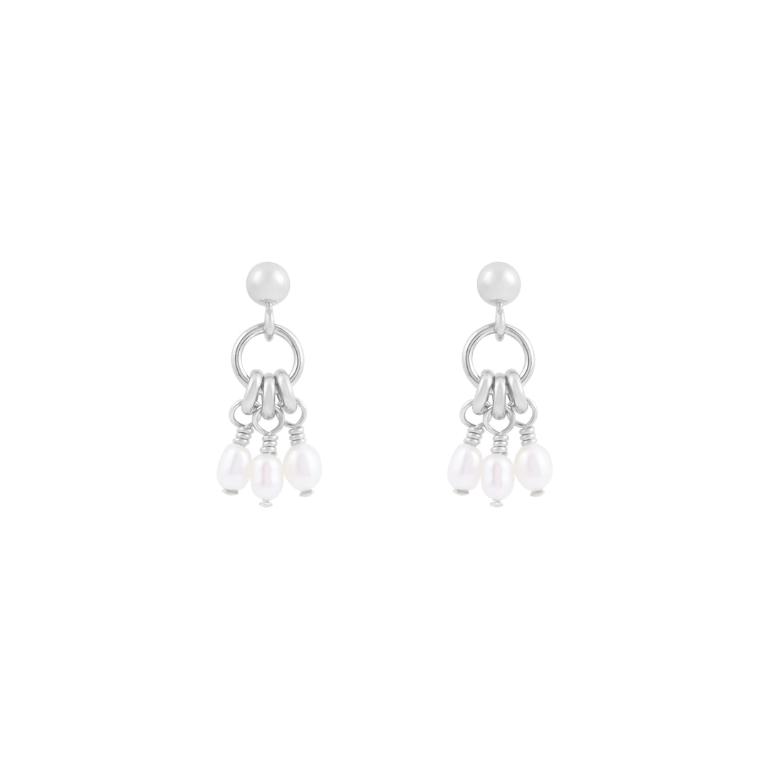 A pair of silver stud earrings with a ring centerpiece and suspended fresh water pearl details.